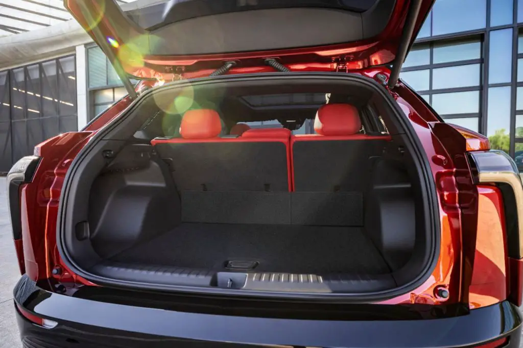 Rear view of 2024 Chevrolet Blazer EV SS in Radiant Red Tintcoat through open trunk. Preproduction model shown. Actual production model may vary. 2024 Chevrolet Blazer EV available Spring 2023.