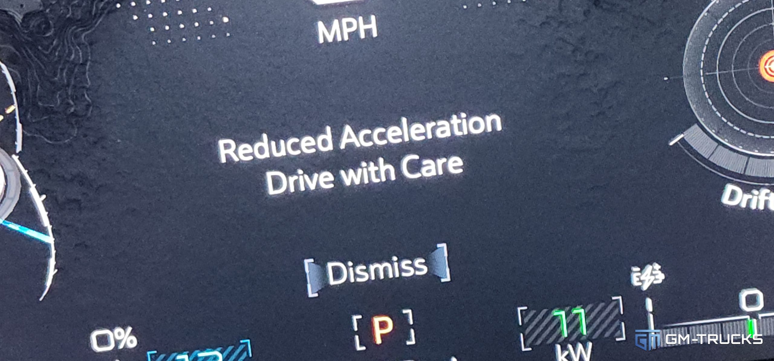 As you run the battery out on the GMC HUMMER EV, warning messages appear on the gauge cluster, including "Reduced Acceleration, Drive With Care"