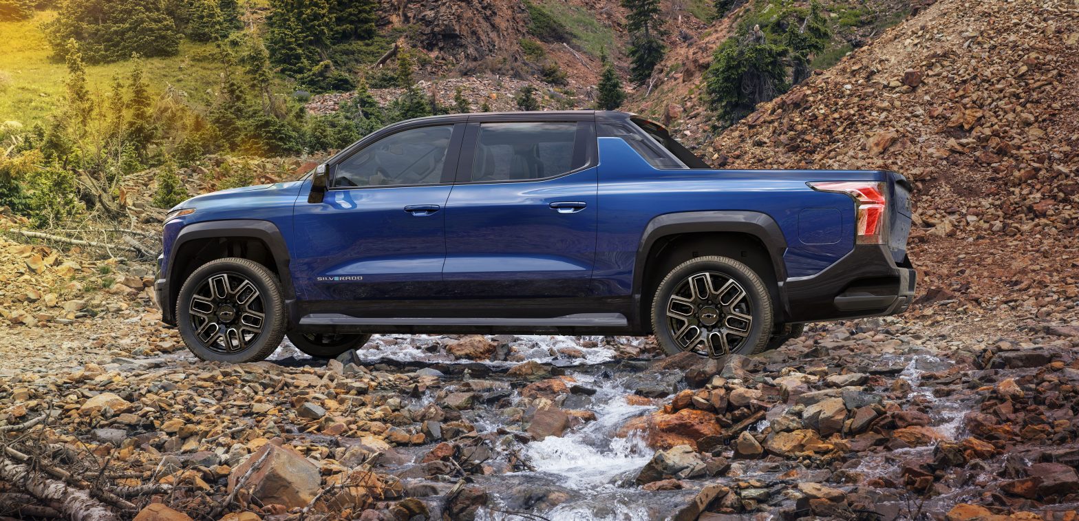 A Silverado EV First Edition RST Crossing A Mountain Stream