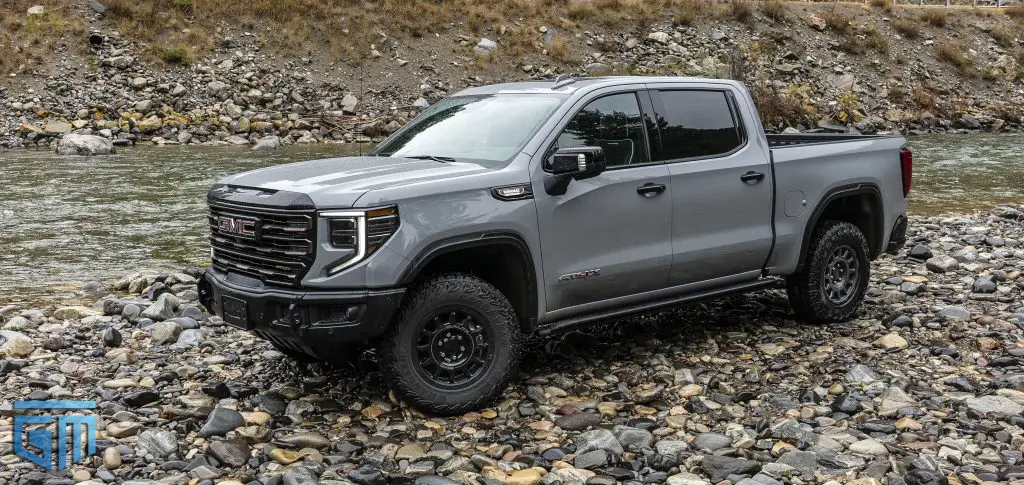 How Many Trucks Has Chevrolet and GMC Sold In 2024 So Far? It's Surprising 3 A 2024 GMC Sierra 1500 AT4X AEV Edition Pickup next to a beautiful river