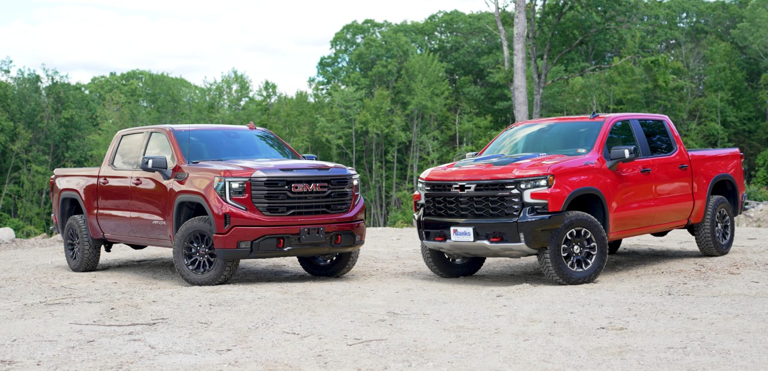 A photo of the GMC Sierra 1500 AT4X and Chevrolet Silverado 1500 ZR2 side by side