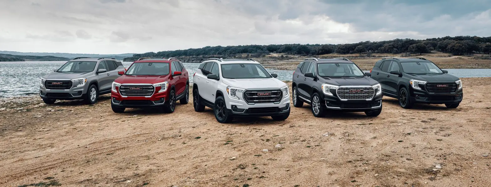 Front group view of the 2024 GMC Terrain lineup, including SLE, SLT, AT4 and Denali trims and available Elevation Edition.