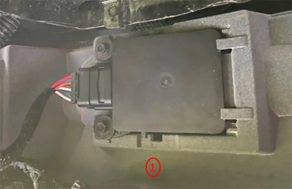 A radar module installed incorrectly (backwards) on the rear bumper of a GM Full-size SUV. 