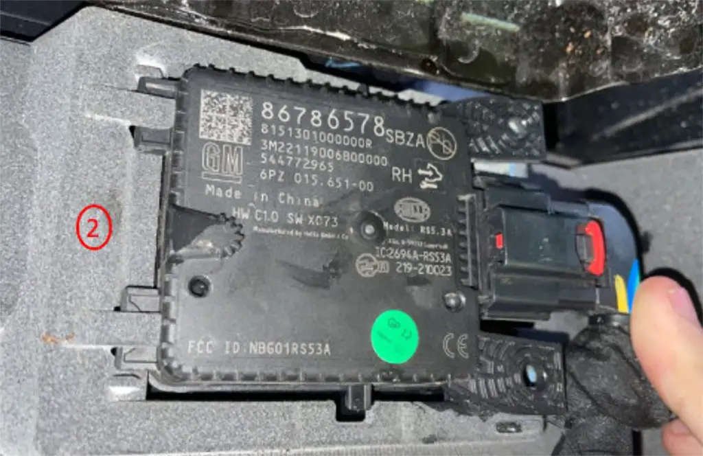 A radar module installed correctly (label facing forwards) on the rear bumper of a GM Full-size SUV. 