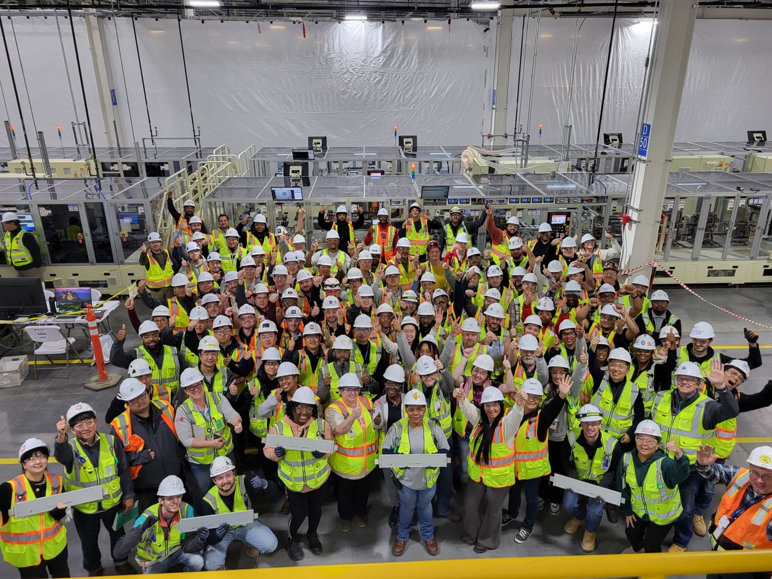 A group of Ultium Cell, LLC Employees Celebrate on the factory floor of the Spring Hill Assembly Plant