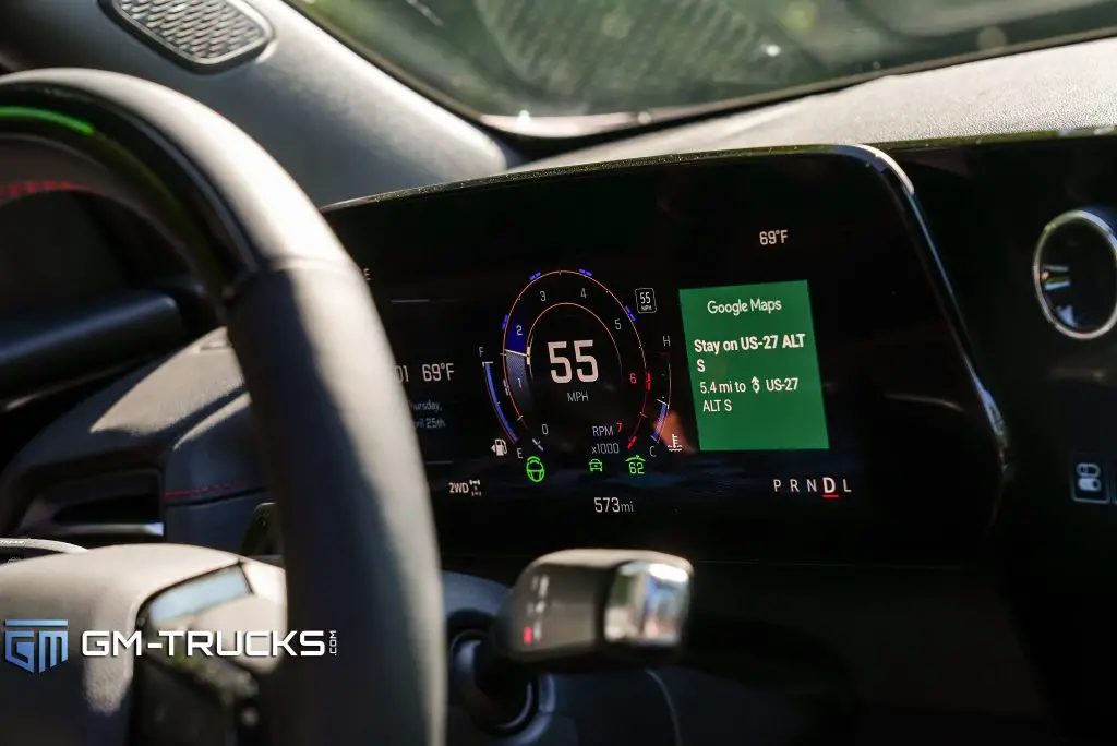 A close up of the 2024 Chevrolet Traverse's electronic column shifter and digital gauge cluster