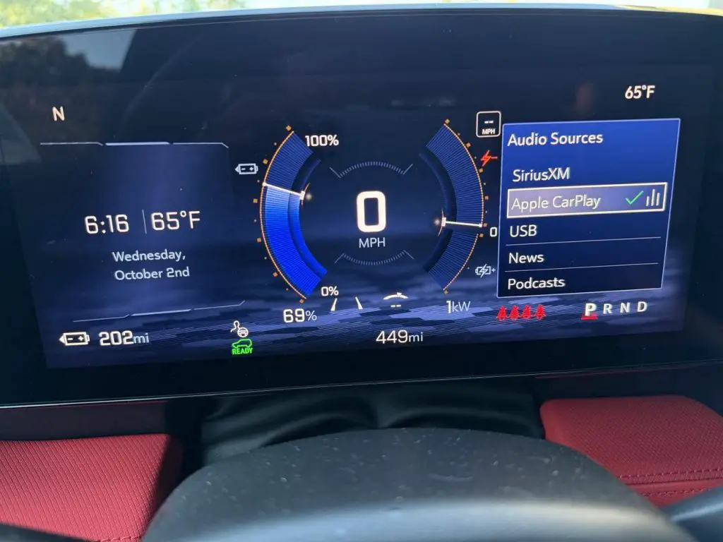 CarPlay and Android Auto for Chevrolet & GMC EVs? White Automotive Just Made It Happen 3 Chevrolet Blazer EV digital gauge cluster showing Apple CarPlay as an available audio source with battery status and range displayed.