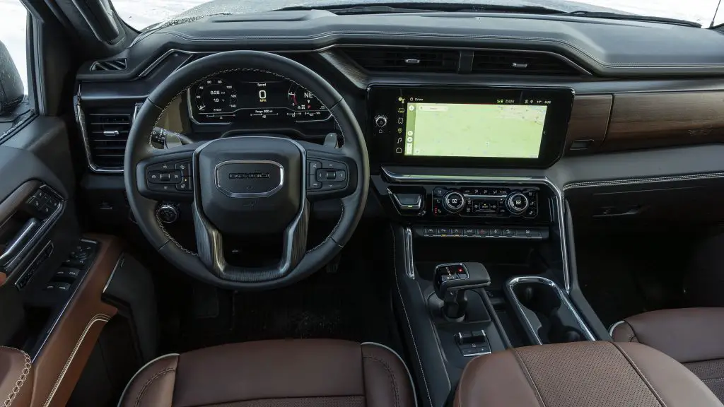 “Yeah, I’d buy this again!” - Chevrolet, GMC, and Cadillac Impress in 2024 Consumer Reports Survey 4 Interior of the GMC Sierra Denali Ultimate showcasing a premium dashboard, leather seats, and advanced infotainment system.
