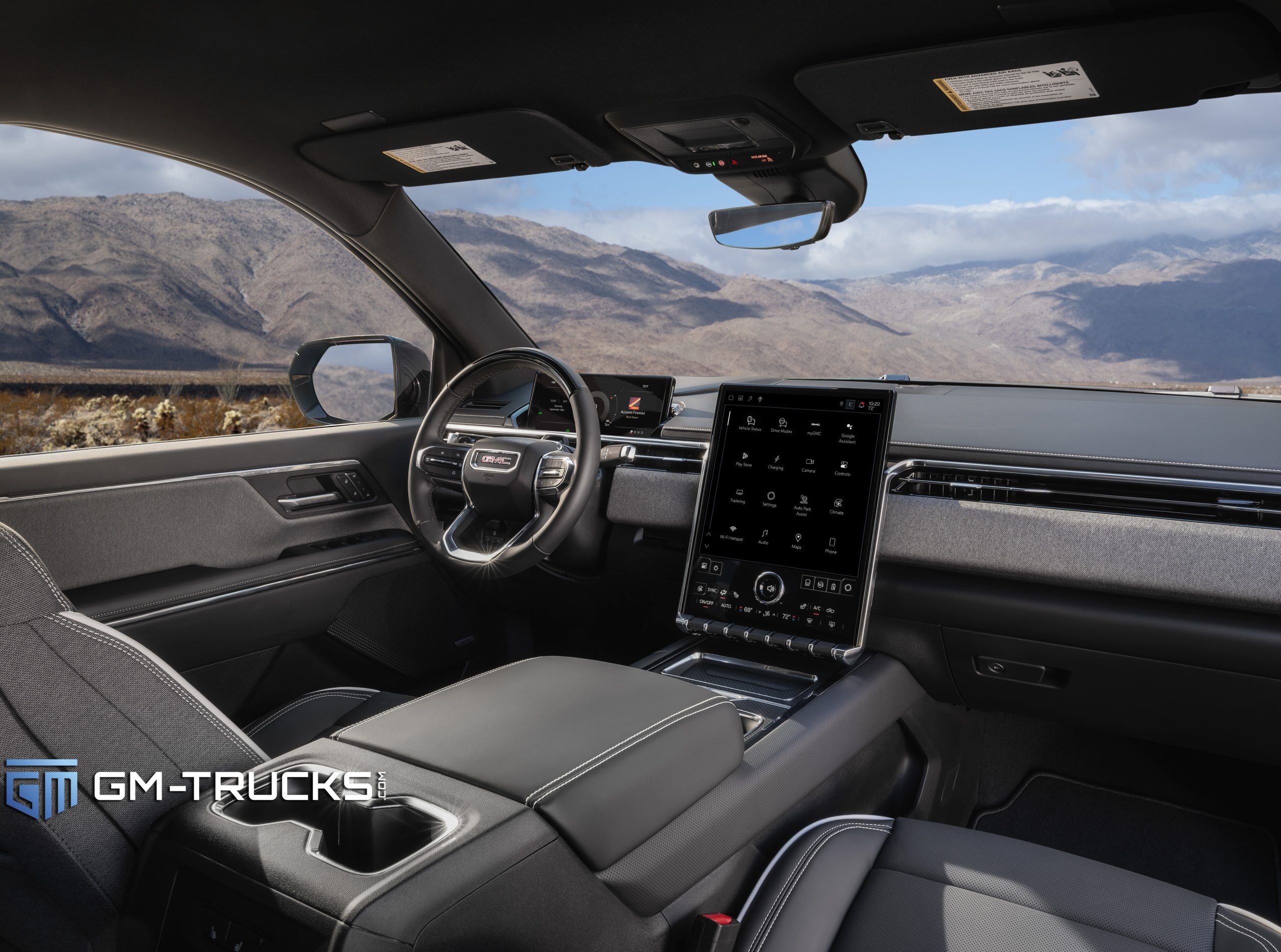 Still Don’t Trust EV Trucks? The 2026 GMC Sierra EV Is Built to Change That With A Lower Price & More Trims 6 Interior view of the 2026 GMC Sierra EV showing the steering wheel, digital gauge cluster, and large 16.8-inch vertical touchscreen with black fabric and contrast stitching.