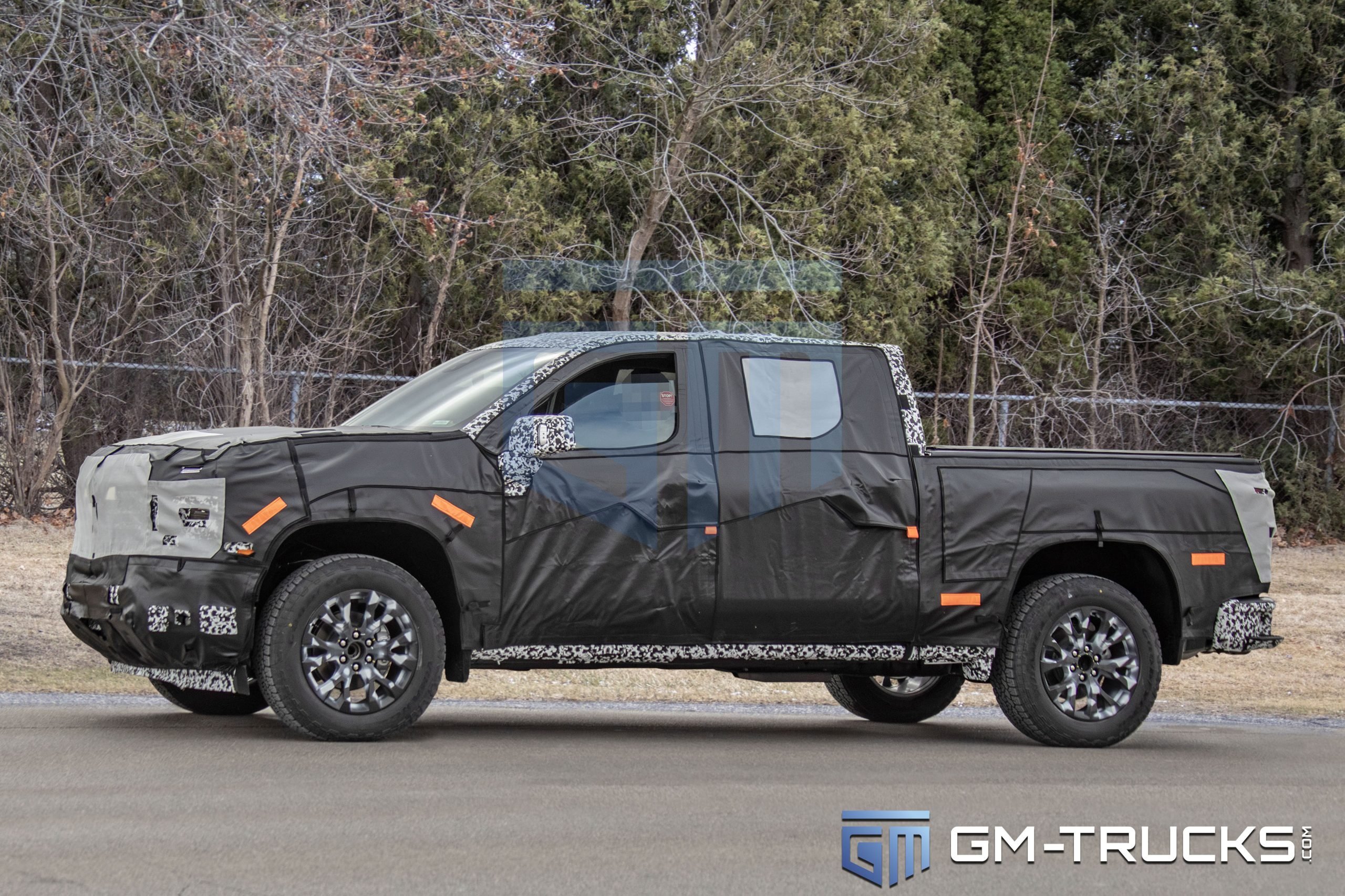 2027 Chevy Silverado Spied with Quad Exhaust, Off-Road Upgrades & High-Tech Interior 2 Camouflaged 2027 Chevrolet Silverado prototype testing on public roads, showcasing updated exterior design, production lighting, and new platform details.