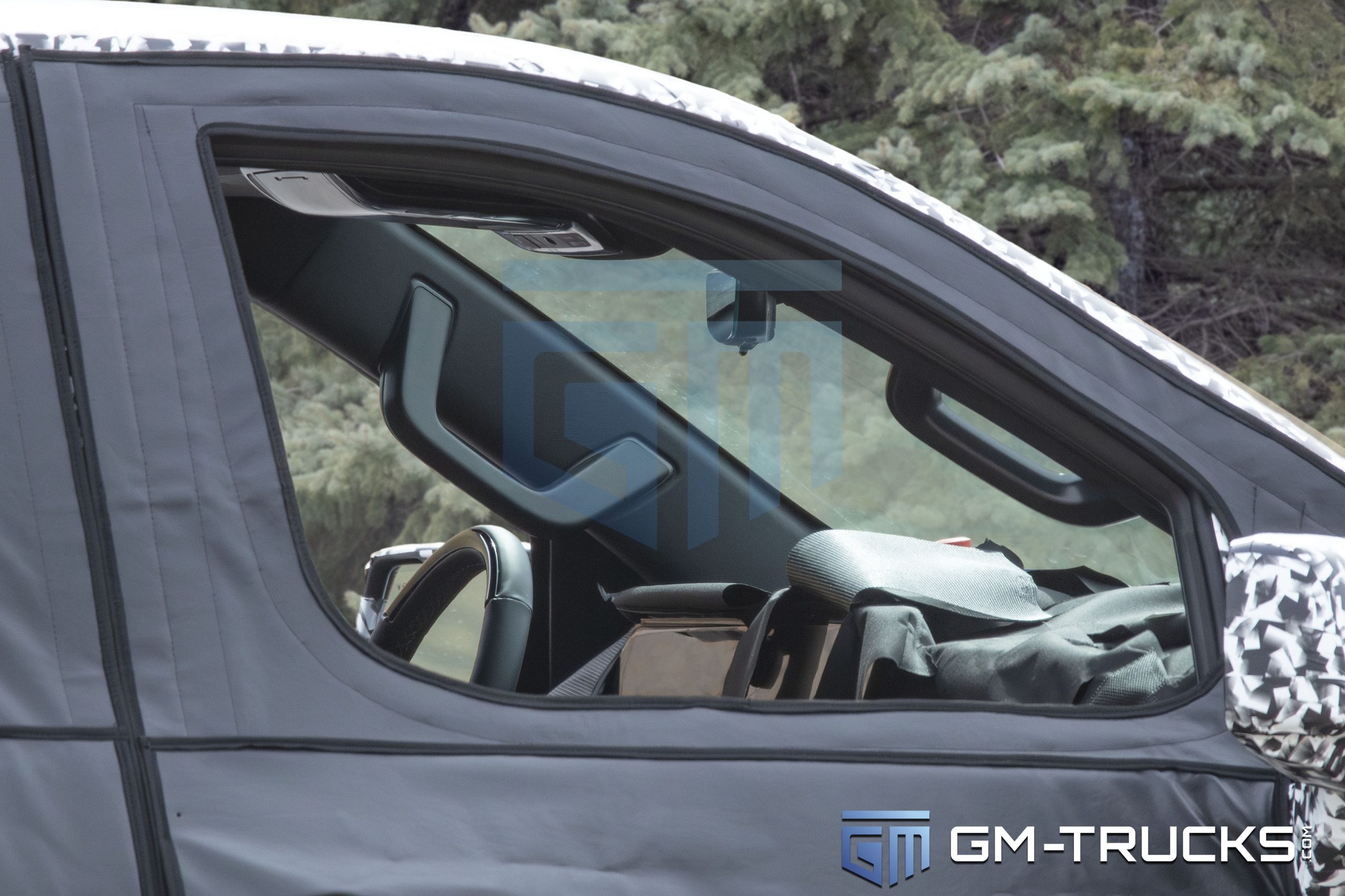 Close-up of the 2027 Chevrolet Silverado prototype’s interior, revealing a large digital display, redesigned steering wheel, and updated cabin details.