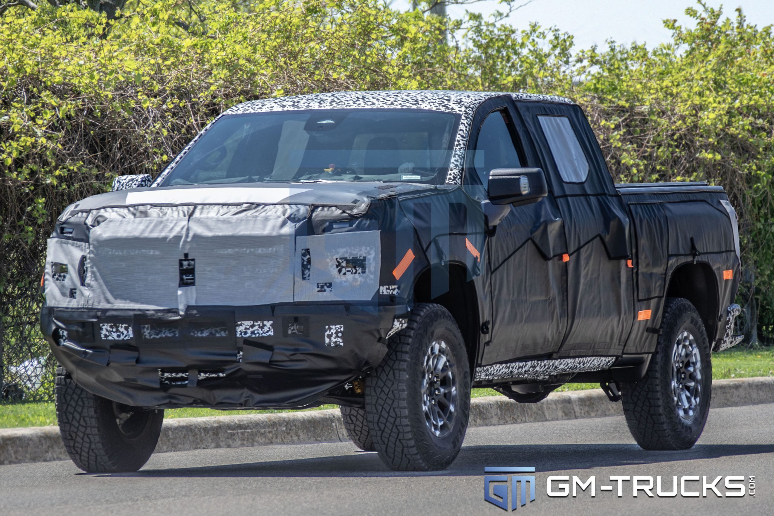 2027 Chevrolet Silverado ZR2 Spy Shots Reveal Major Off-Road Upgrade 5 Front view of camouflaged 2027 Chevrolet Silverado ZR2 prototype during public road testing