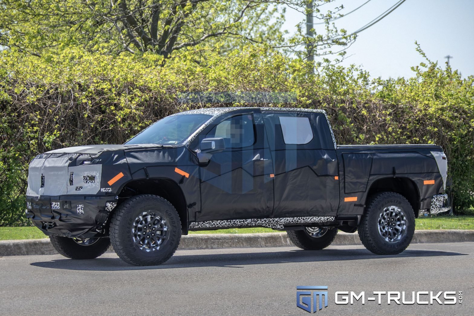 2027 Chevrolet Silverado ZR2 prototype testing with 35-inch Goodyear tires in camouflage wrap