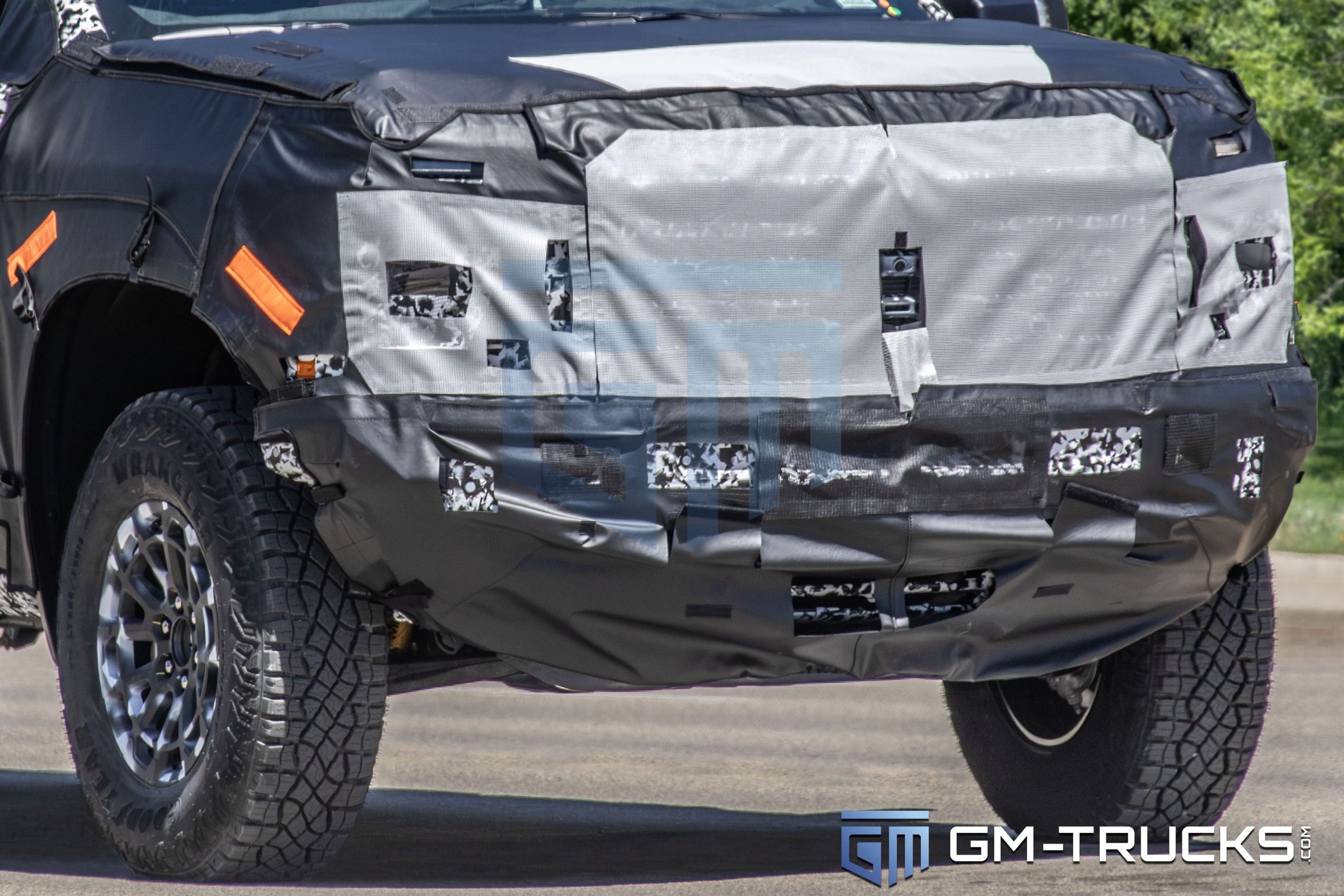 2027 Chevrolet Silverado ZR2 Spy Shots Reveal Major Off-Road Upgrade 7 Camouflaged front end of the 2027 Chevrolet Silverado ZR2 prototype with masked grille and headlights