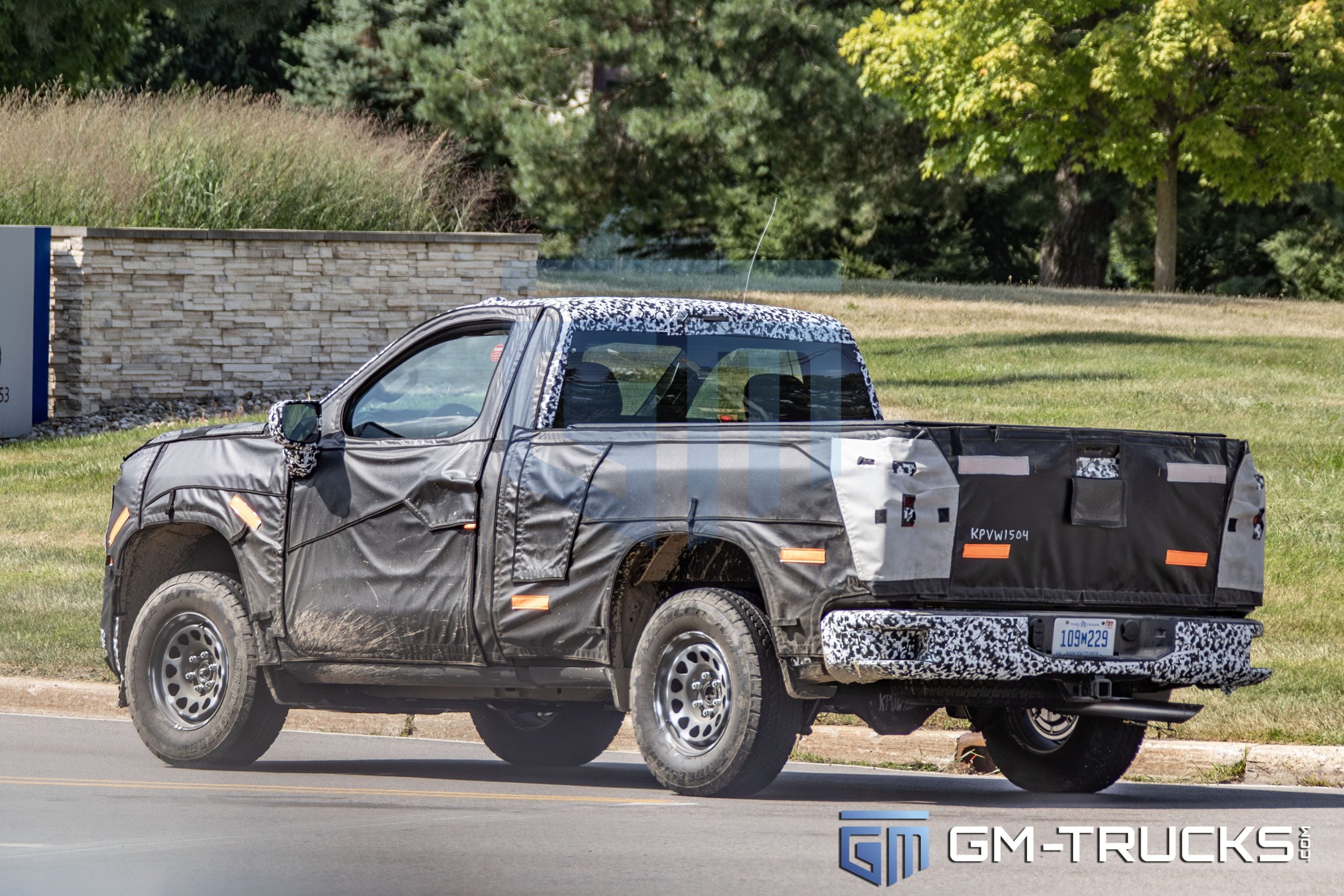 2027 Silverado WT Regular Cab Spied with LED Lights and Bold New Grille 3 2027 Chevrolet Silverado 1500 WT prototype in Regular Cab configuration driving with camouflaged rear and side panels