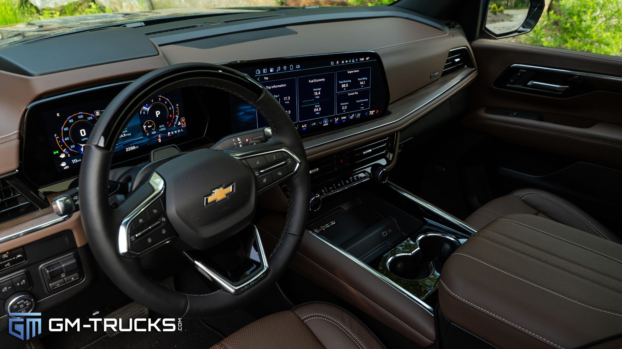 The $114,655 Chevy: I Maxed-Out A 2026 Suburban 4 The driver's seat view of a 2025 Chevrolet Tahoe High Country interior featuring Jet Black and Mocha leather trim, a digital instrument cluster, and a 17.7-inch center touchscreen.