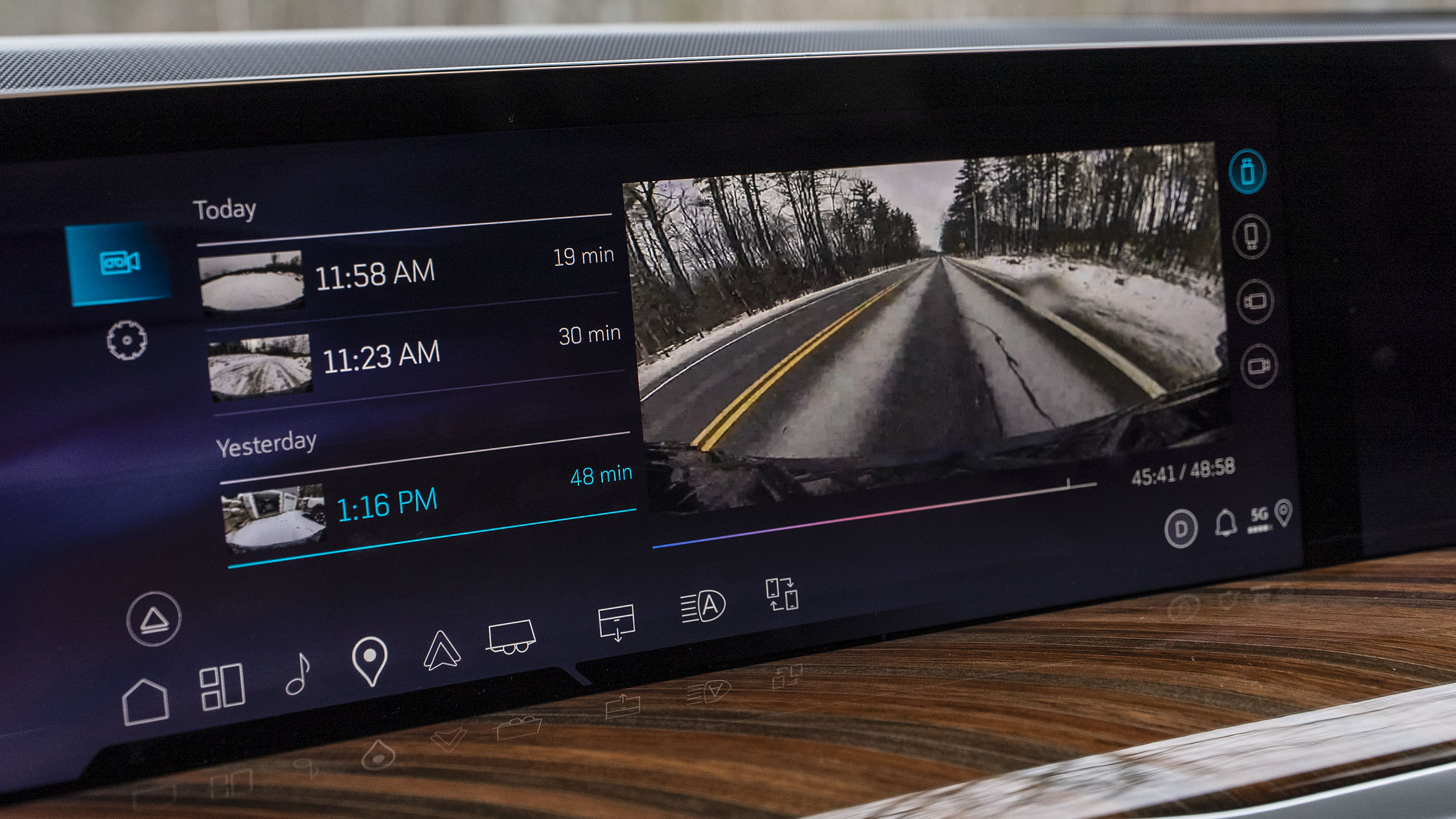 Power Open Doors, Night Vision & 55-Inch Displays: 5 Wild Tech Features on the 2026 Escalade 6 Close-up of the 2026 Cadillac Escalade infotainment screen showing the video playback interface for the integrated camera system, with a list of recorded clips and a front-facing road view video.