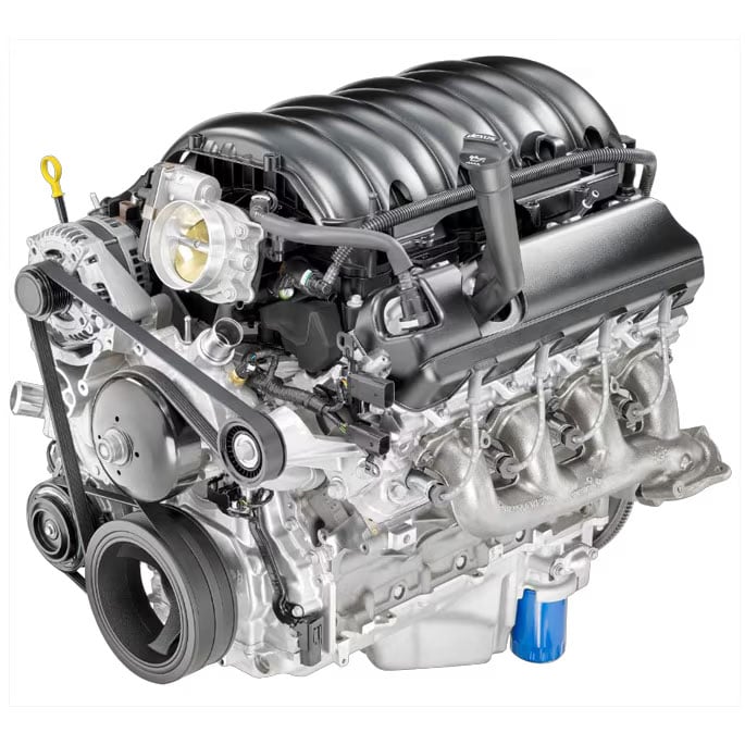 Is GM’s 6.2L V8 Engine Recall Failing? The Government Is Now Investigating 2 A studio photograph of the General Motors L87 6.2L V8 engine on a white background, highlighting the intake manifold, throttle body, exhaust headers, and front accessory drive belt.