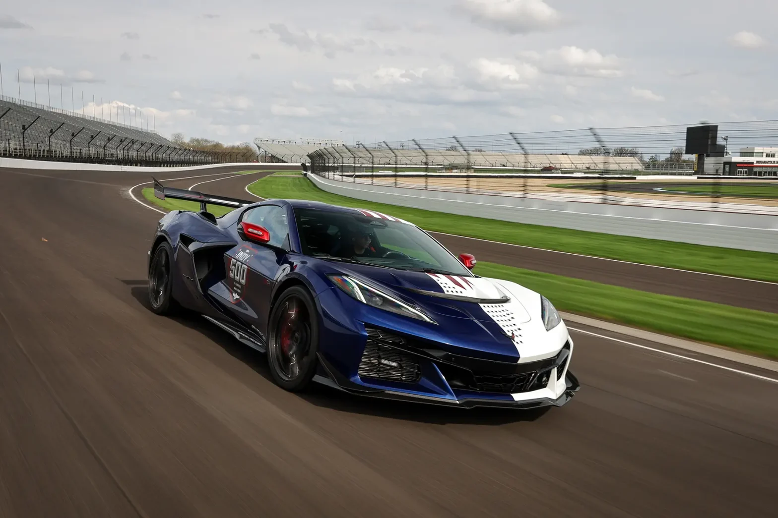 The 2026 Chevrolet Corvette ZR1X Pace Car featuring a patriotic split Admiral Blue and Arctic White stars and stripes livery driving on the track at the Indianapolis Motor Speedway.