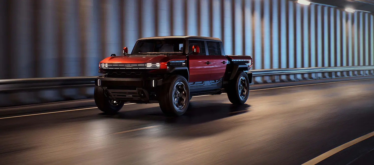 The tactical tan GMC HUMMER X mid-size electric pickup truck concept parked outside the GM Advanced Design Pasadena Studio in California.